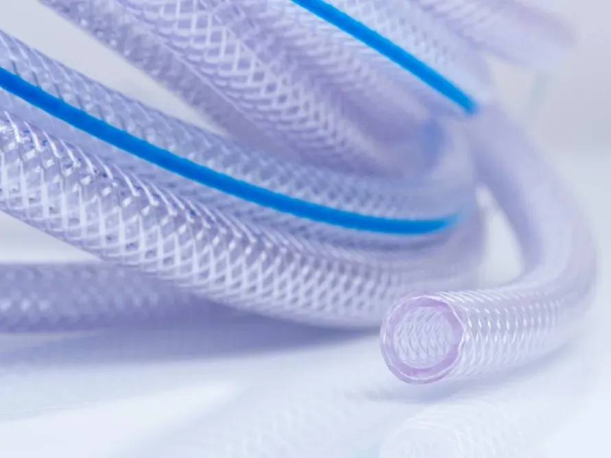 Clear braided PVC garden hosepipe with a blue stripe