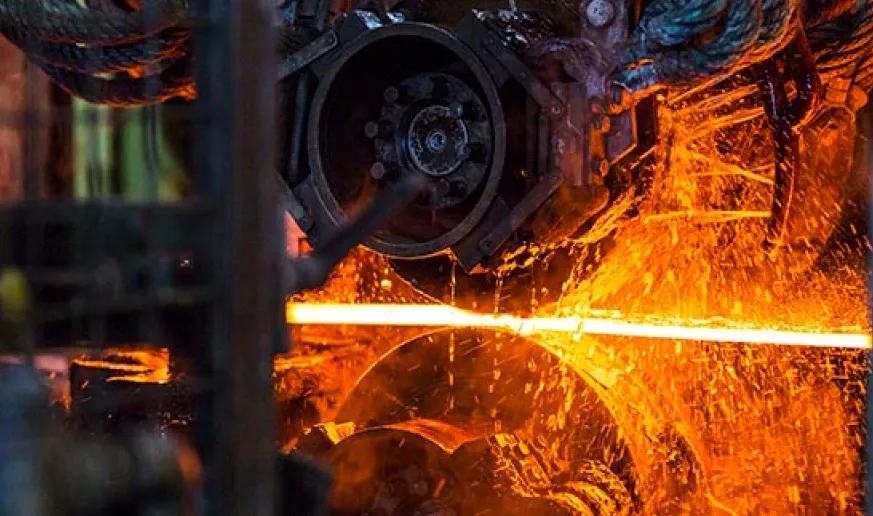 A glowing steel bar on the rolling line